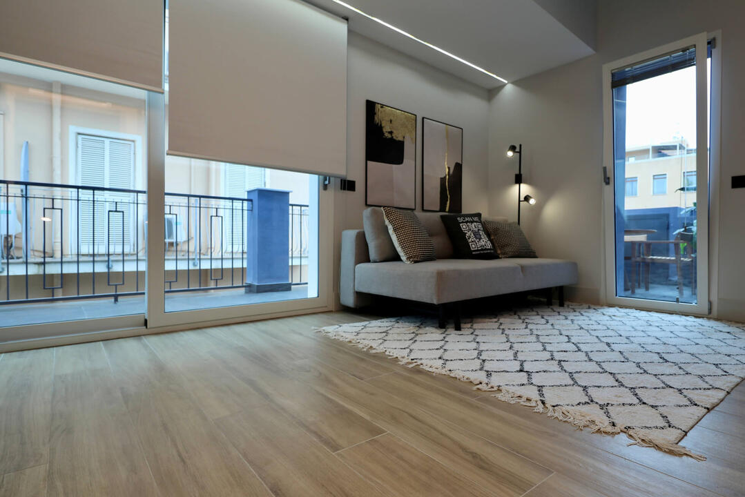 Spacious living area with a 2-person sofa sofa bed and large TV.