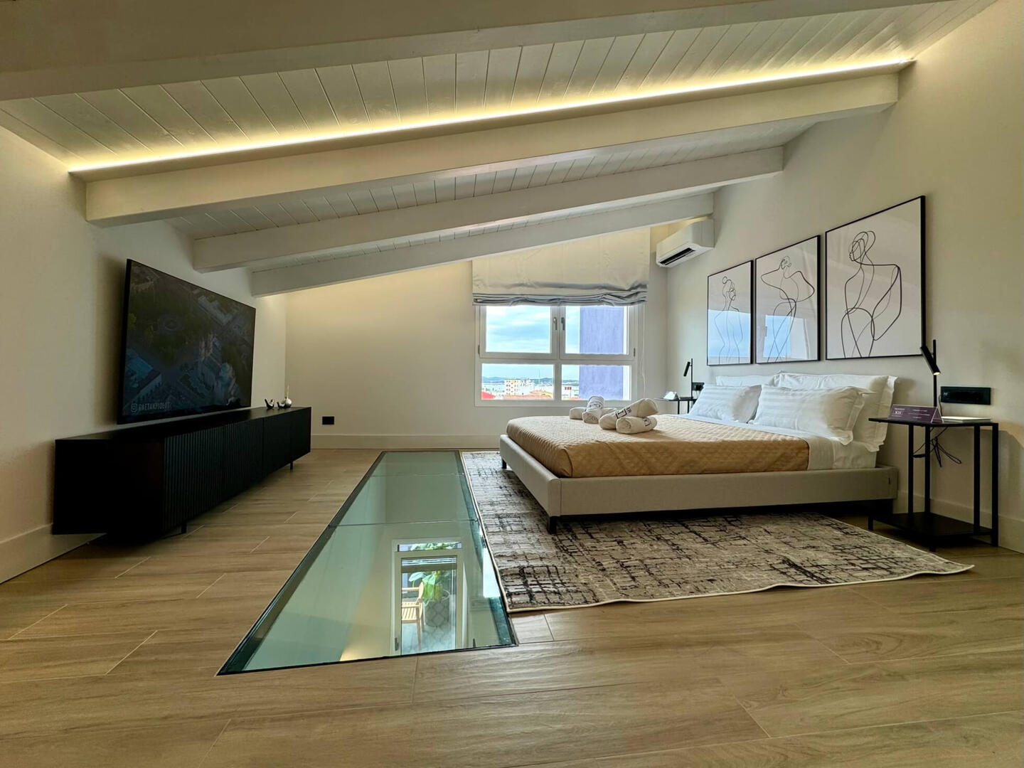 Large king-size bed with premium linen, custom-made pillows, and a quality mattress. The TV is 65&quot;.